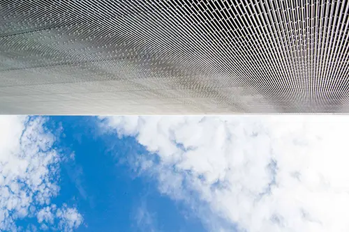 Upside down view of a building wall and the sky