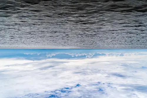 Upside down view of the ocean and the sky