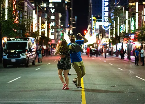 Two people dancing in the middle of downtown Vancouver