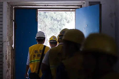 Construction workers walking out of a building